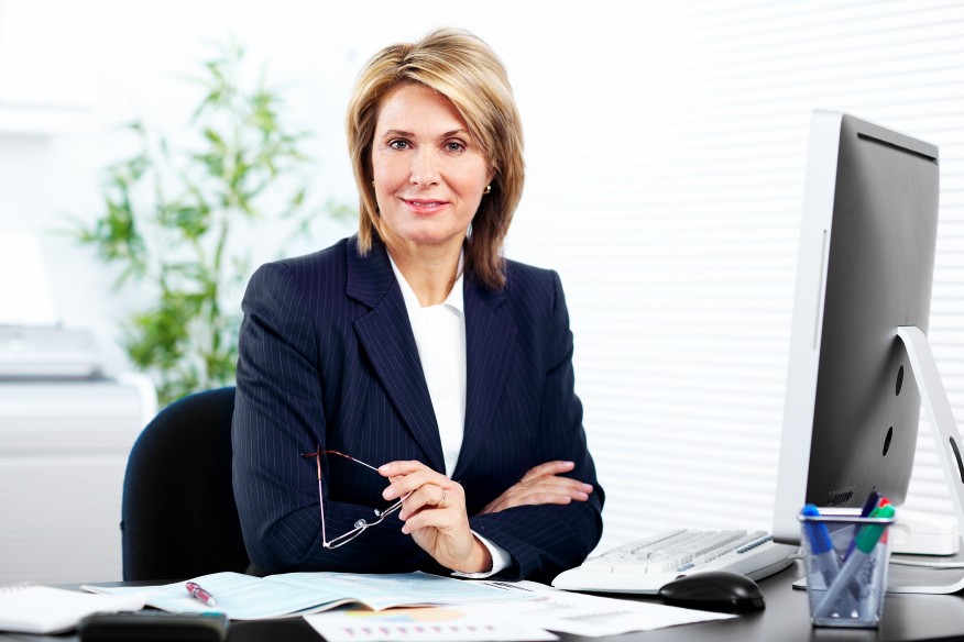 mature woman posing at a desk